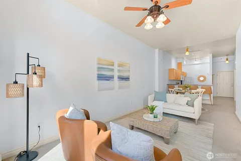 a living room with furniture and a chandelier