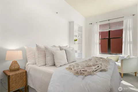 a bedroom with a bed and a window