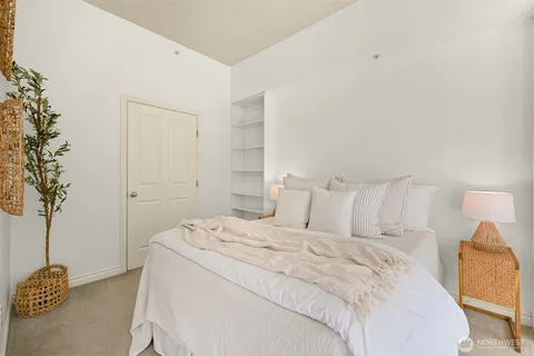 a bed room with a bed and a chair