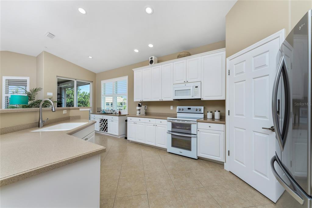 3316 Sunset Key Circle, Unit D Punta Gorda, FL 33955 - Photo 12 of 68 a kitchen with white cabinets and stainless steel appliances