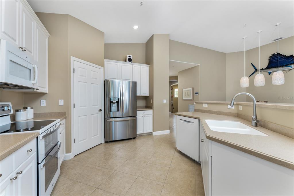 3316 Sunset Key Circle, Unit D Punta Gorda, FL 33955 - Photo 13 of 68 a kitchen with a sink and refrigerator