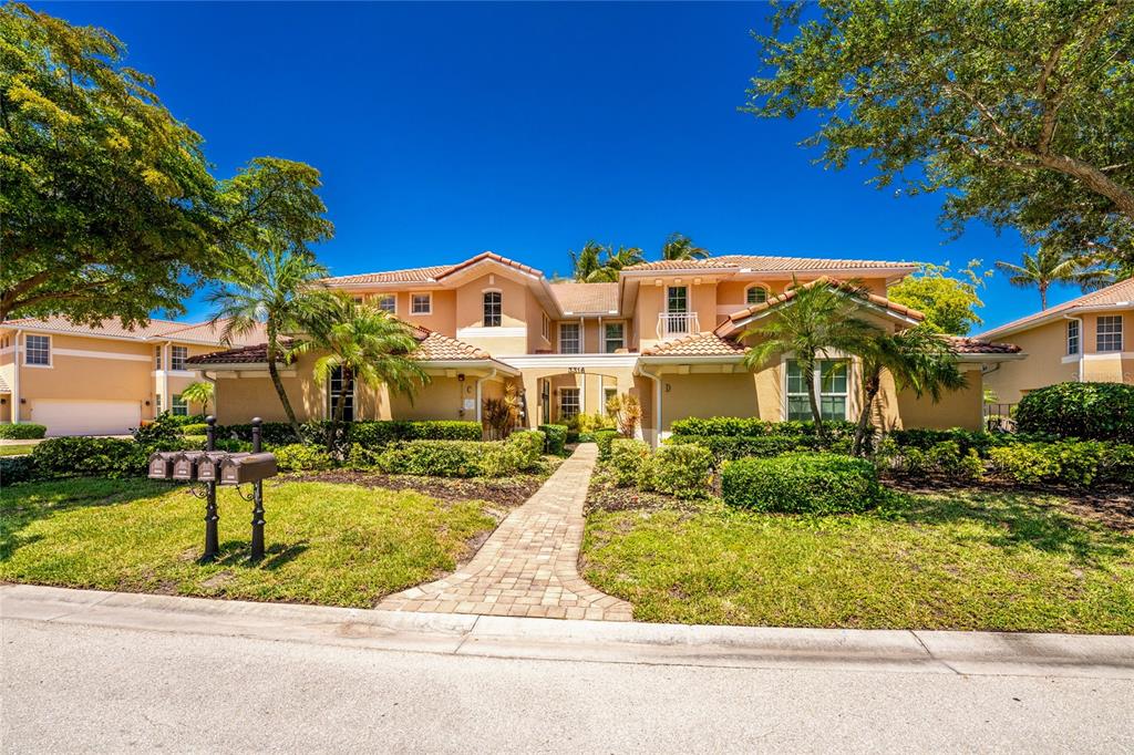 3316 Sunset Key Circle, Unit D Punta Gorda, FL 33955 - Photo 2 of 68 a front view of a house with a yard