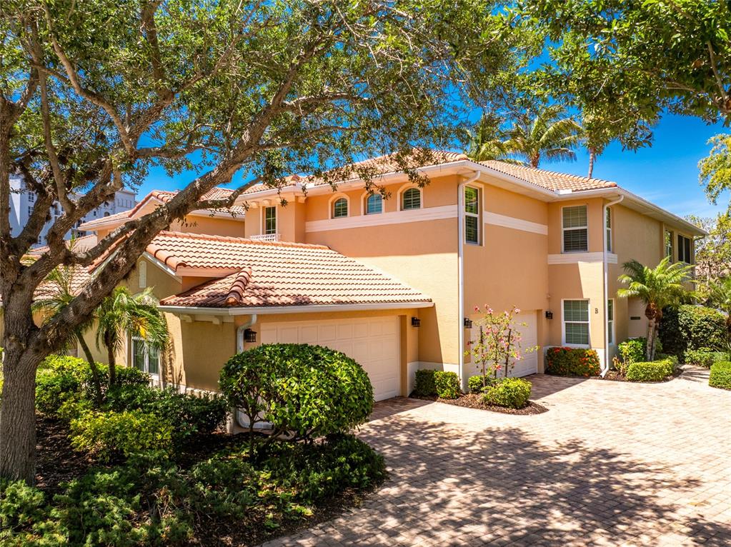 3316 Sunset Key Circle, Unit D Punta Gorda, FL 33955 - Photo 3 of 68 a front view of a house with a yard and garage