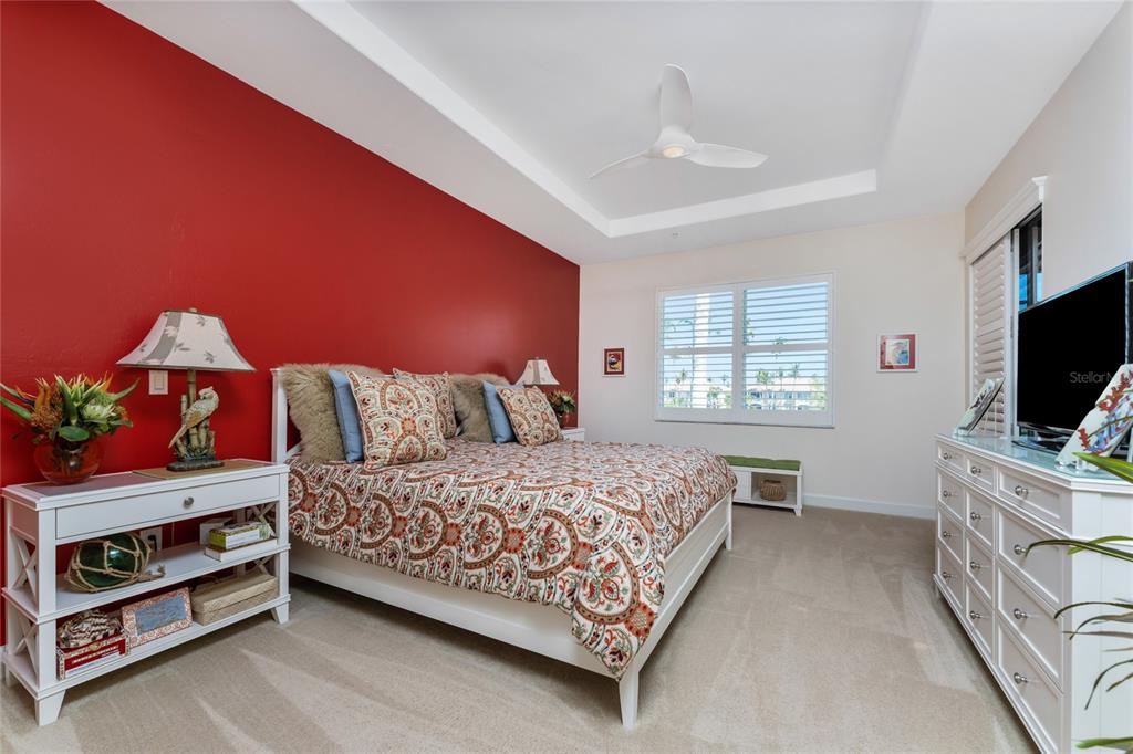 3316 Sunset Key Circle, Unit D Punta Gorda, FL 33955 - Photo 31 of 68 a bedroom with a bed and a flat screen tv