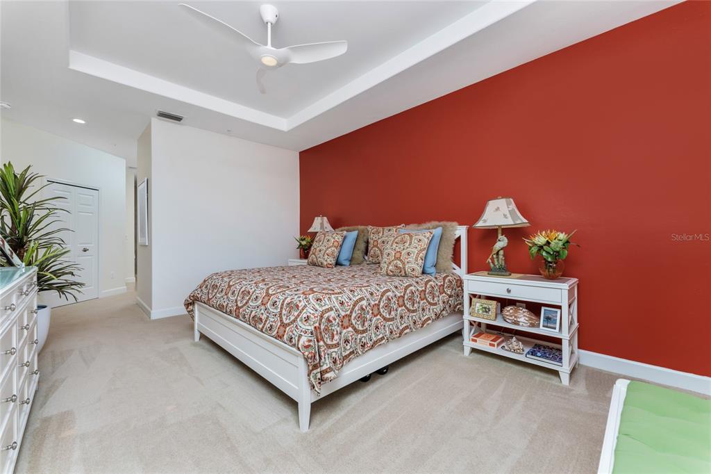 3316 Sunset Key Circle, Unit D Punta Gorda, FL 33955 - Photo 34 of 68 a bedroom with a bed and a potted plant