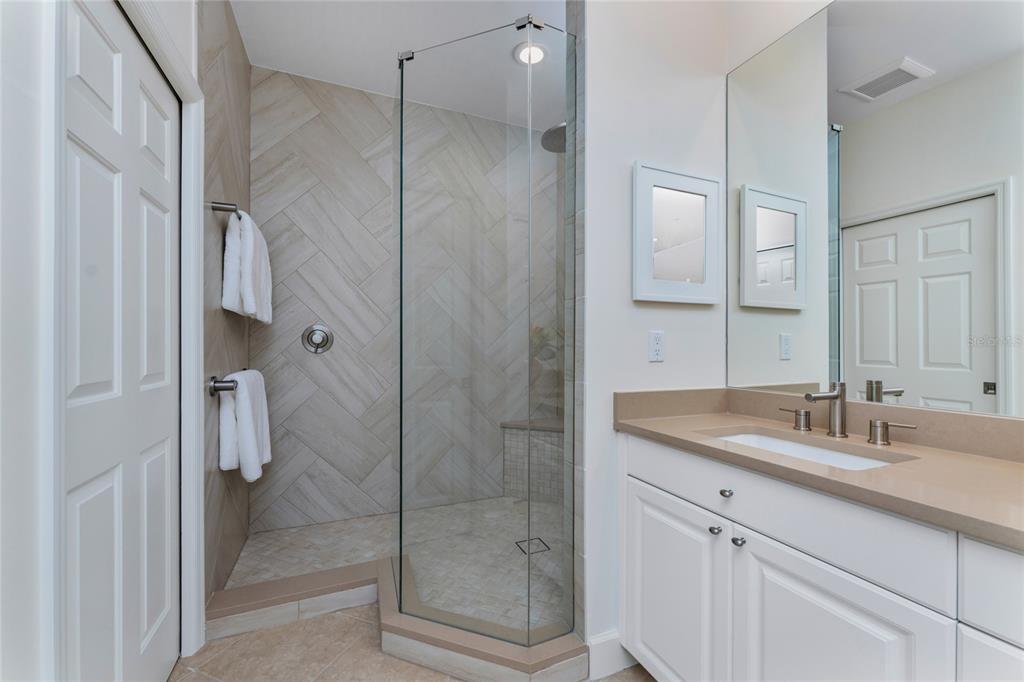 3316 Sunset Key Circle, Unit D Punta Gorda, FL 33955 - Photo 36 of 68 a bathroom with a shower sink and mirror