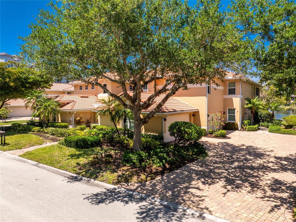 3316 Sunset Key Circle, Unit D Punta Gorda, FL 33955 - Photo 41 of 68 a front view of a house with garden and trees