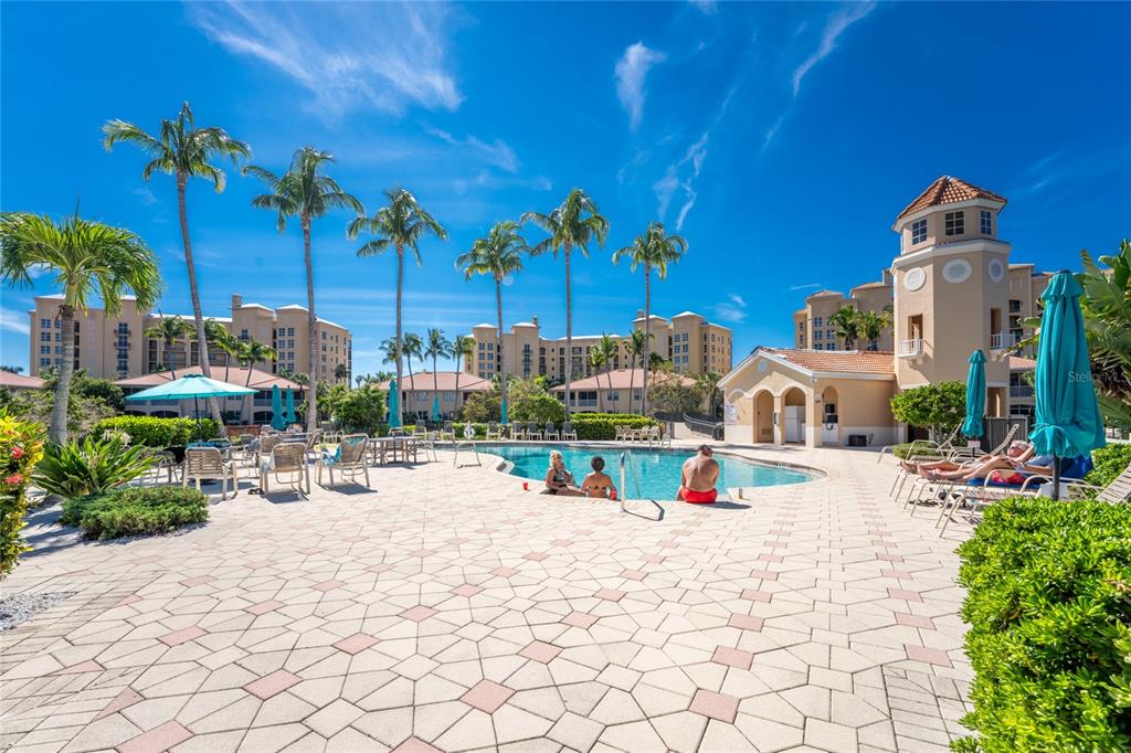 3316 Sunset Key Circle, Unit D Punta Gorda, FL 33955 - Photo 49 of 68 a view of swimming pool with a lawn chairs under an umbrella