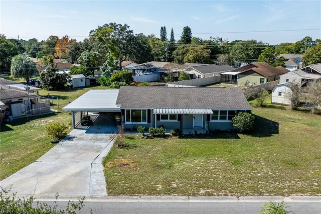 an aerial view of a house with swimming pool garden and patio