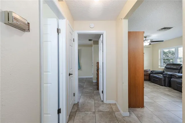 a view of a hallway with living room and dining room