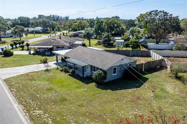 an aerial view of a house with swimming pool garden and outdoor seating