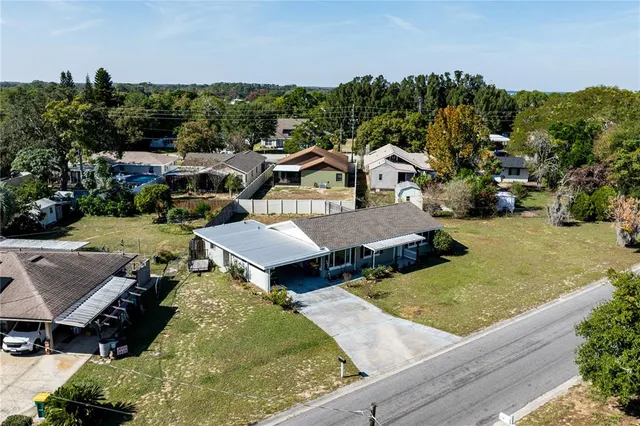 an aerial view of a house with garden space and street view