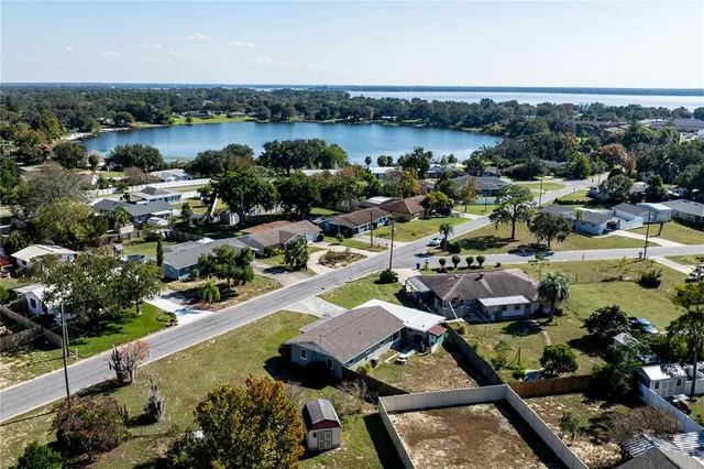an aerial view of a house with a lake view