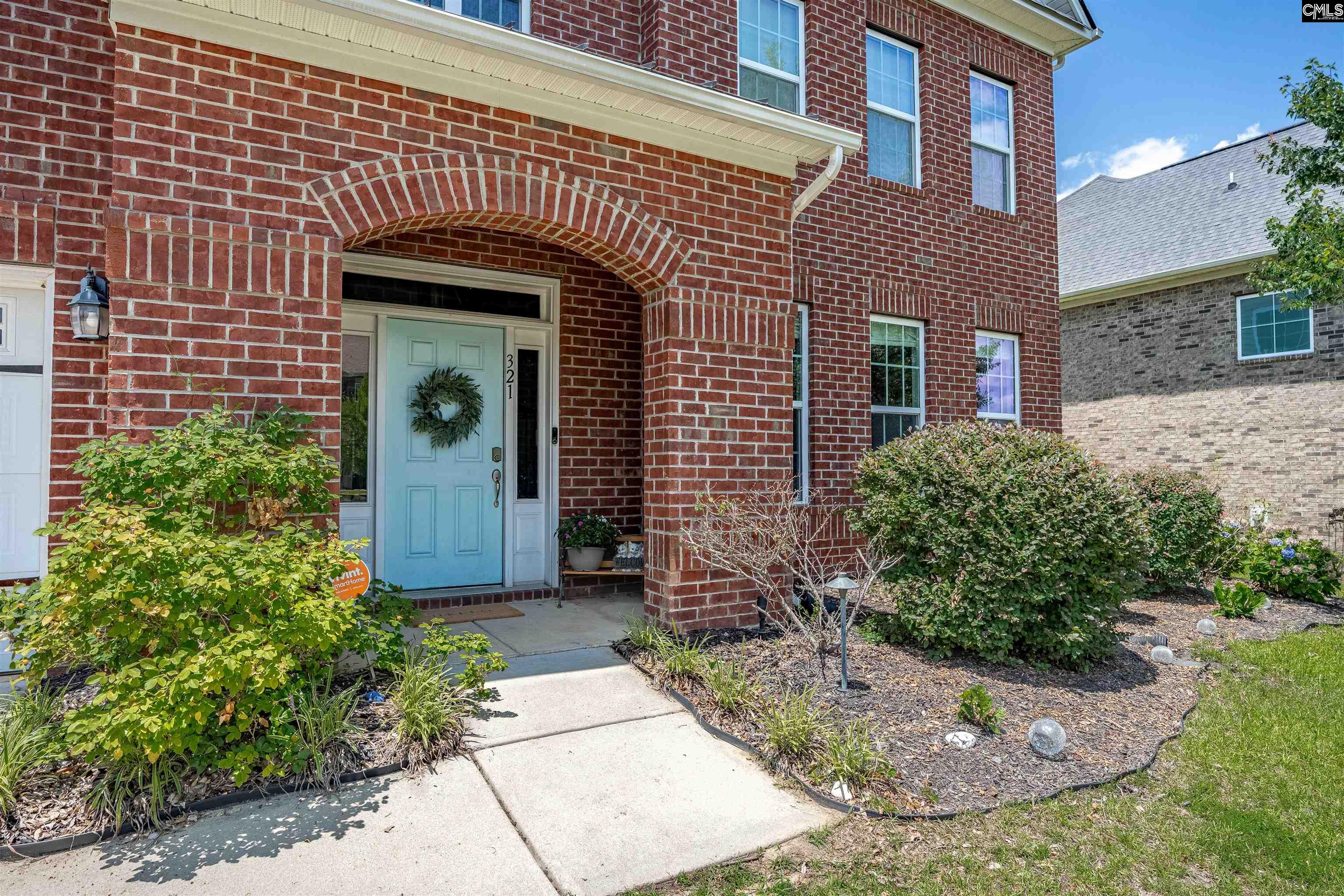 321 Asa Rose Lexington, SC 29072 - Photo 2 of 52 a view of a brick house with potted plants