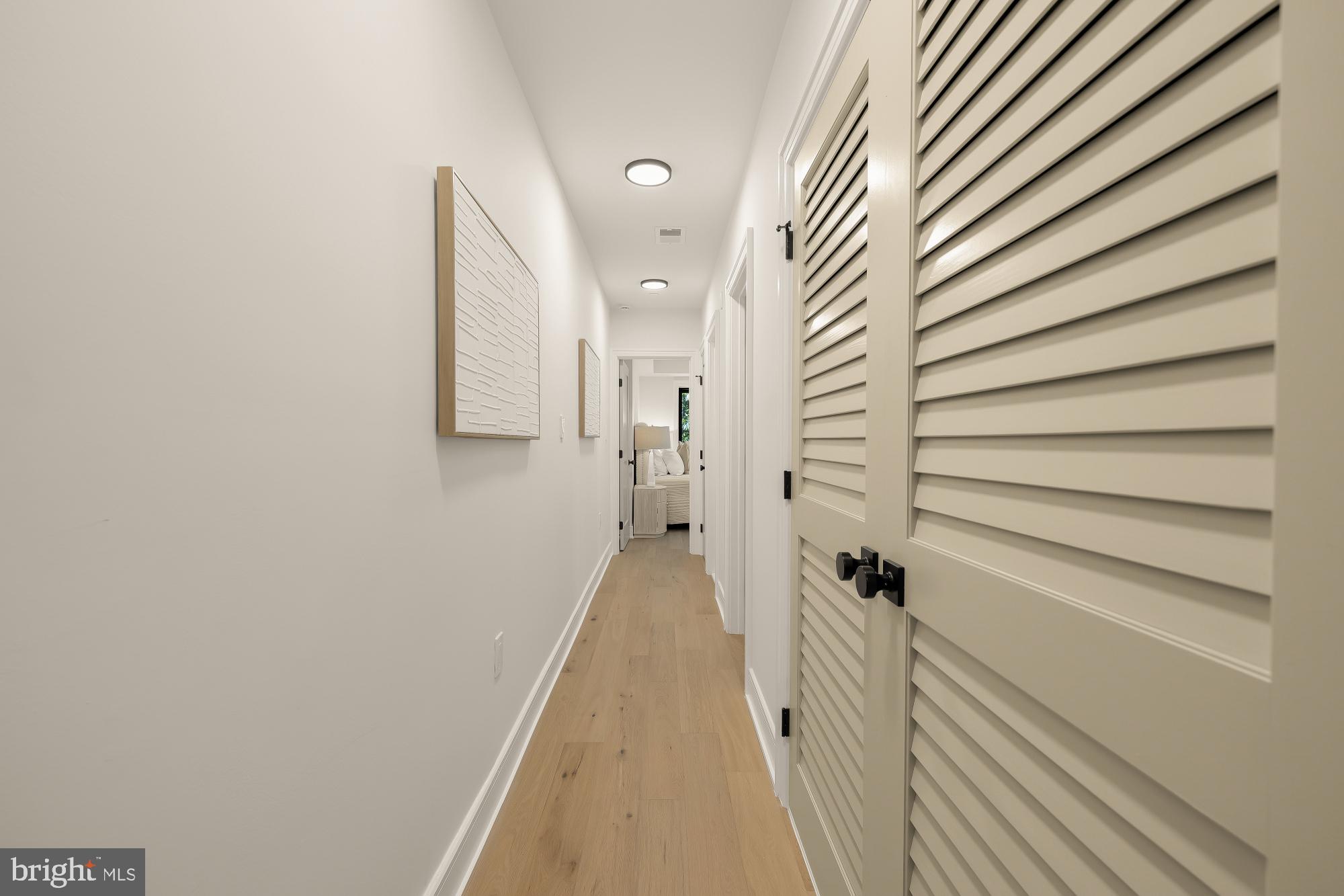1463 Harvard Street Northwest, Unit 2 Washington, DC 20009 - Photo 11 of 25 a view of a hallway with wooden floor and a window