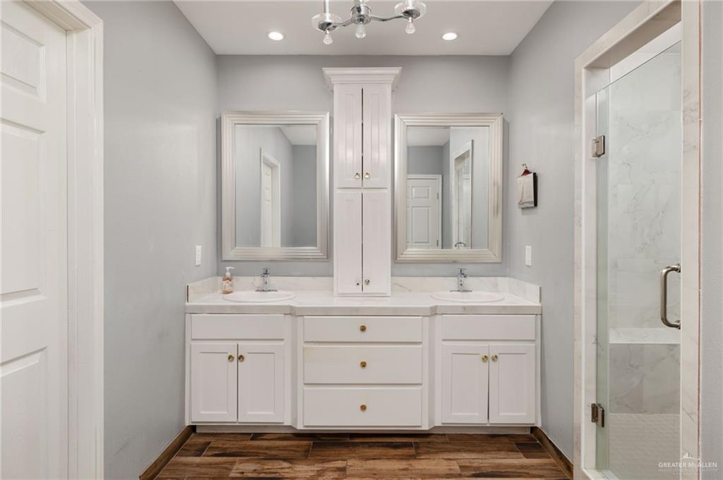 2507 East Mile 5 Road Mission, TX 78573 - Photo 18 of 34 a bathroom with a double vanity sink and mirror