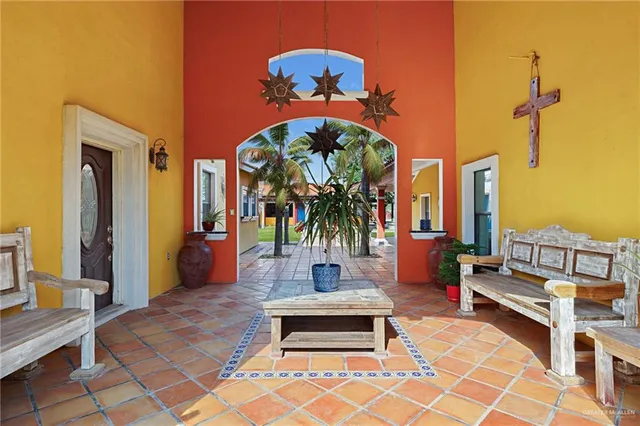 a living room with furniture a flat screen tv and a table