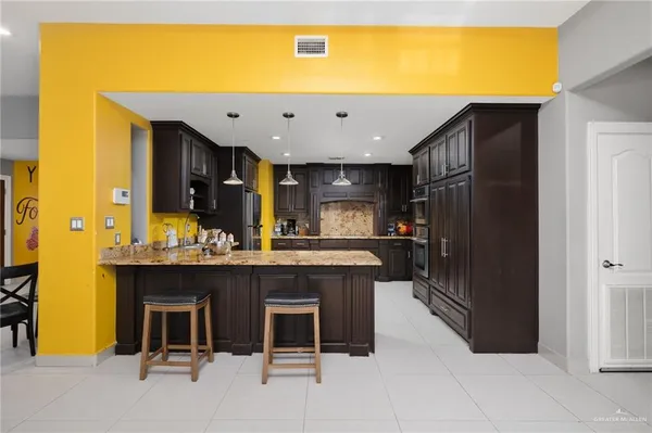 a view of a dining room with furniture and chandelier