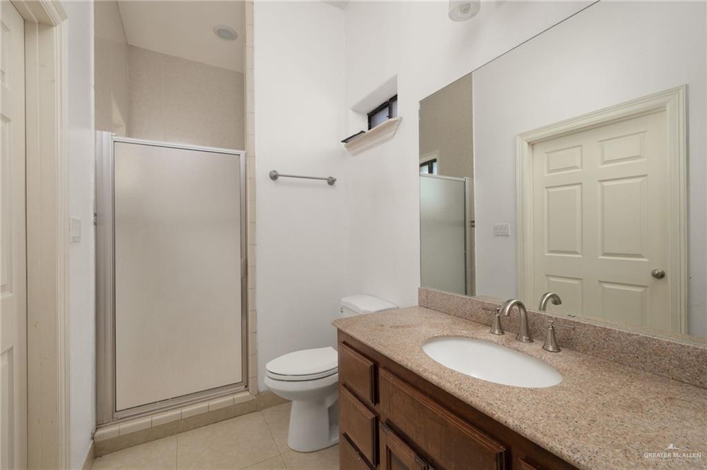 2507 East Mile 5 Road Mission, TX 78573 - Photo 32 of 34 a bathroom with a granite countertop sink toilet and shower