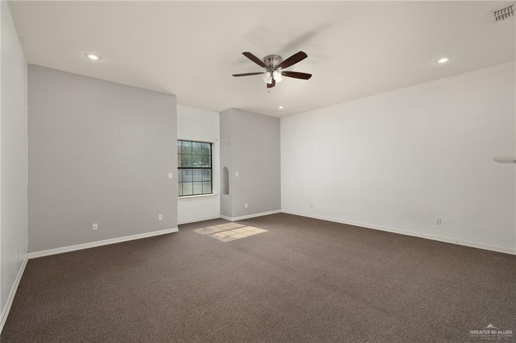 2507 East Mile 5 Road Mission, TX 78573 - Photo 33 of 34 an empty room with a ceiling fan and window