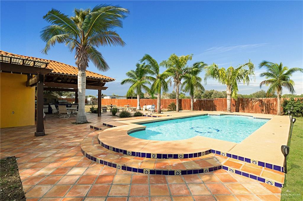 2507 East Mile 5 Road Mission, TX 78573 - Photo 8 of 34 a view of a swimming pool with a lounge chairs