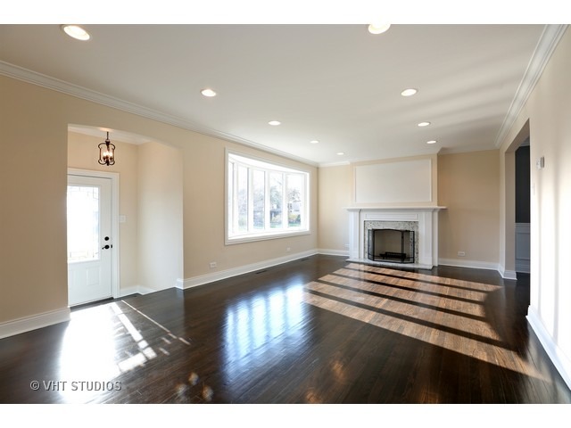 570 Byrd Road Riverside, IL 60546 - Photo 2 of 16 a view of empty room with fireplace and wooden floor
