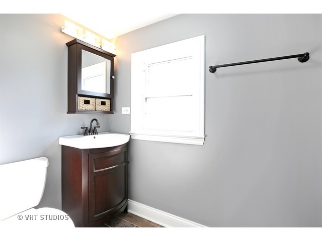 570 Byrd Road Riverside, IL 60546 - Photo 13 of 16 a bathroom with a sink a toilet and mirror