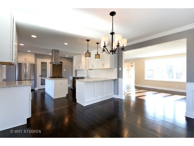 570 Byrd Road Riverside, IL 60546 - Photo 6 of 16 a view of a kitchen with stainless steel appliances wooden floor and large windows