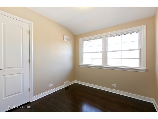 570 Byrd Road Riverside, IL 60546 - Photo 8 of 16 an empty room with wooden floor and windows