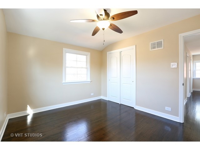 570 Byrd Road Riverside, IL 60546 - Photo 9 of 16 a view of an empty room with wooden floor and a ceiling fan