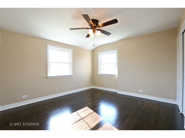 570 Byrd Road Riverside, IL 60546 - Photo 10 of 16 a view of an empty room with wooden floor and a window