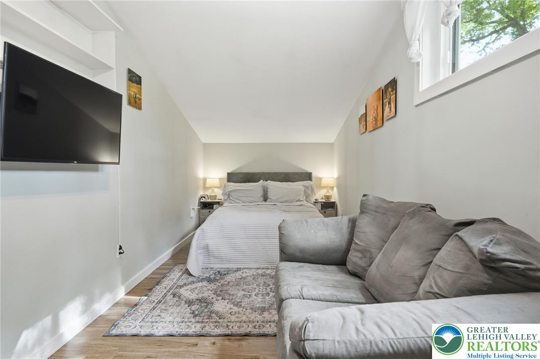 9033 Loop Road Slatington, PA 18080 - Photo 29 of 53 Hardwood flooring and abundant light enhance this functional bedroom space.