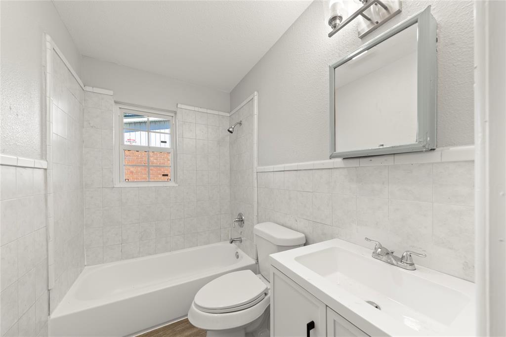 1406 Ridgeview Street Mesquite, TX 75149 - Photo 13 of 16 a bathroom with a sink toilet and shower