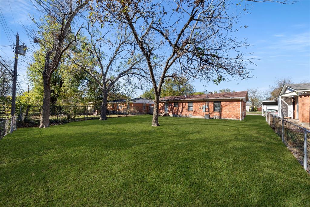 1406 Ridgeview Street Mesquite, TX 75149 - Photo 16 of 16 a view of a yard with a house in the background