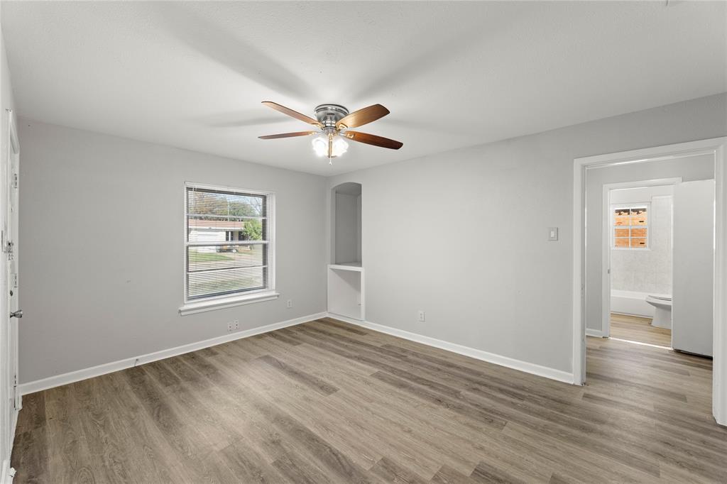 1406 Ridgeview Street Mesquite, TX 75149 - Photo 5 of 16 a view of an empty room with a window and wooden floor