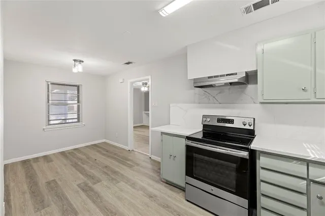 a kitchen with a stove and a microwave