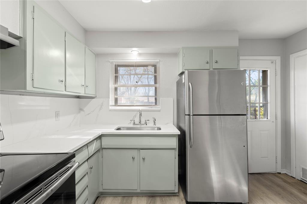 1406 Ridgeview Street Mesquite, TX 75149 - Photo 9 of 16 a white refrigerator freezer sitting inside of a kitchen