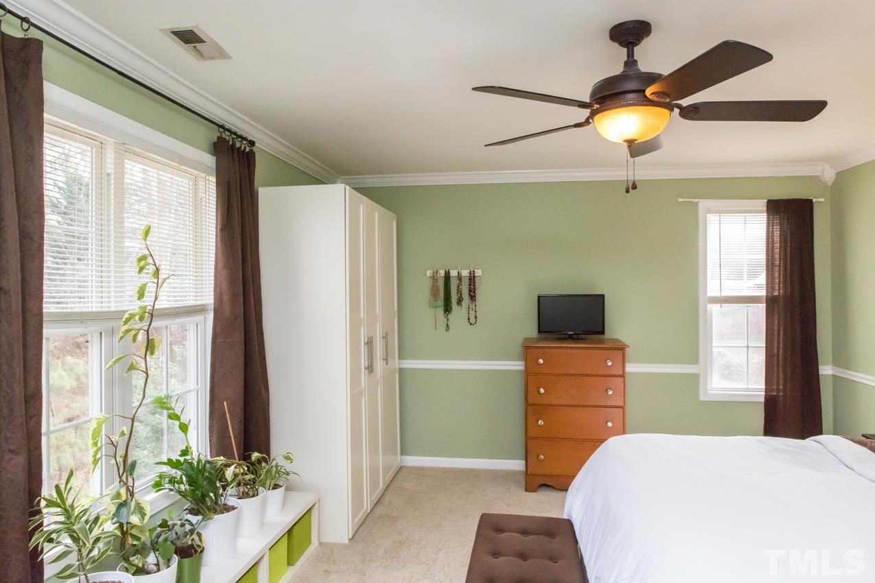 9108 Castleton Lane Raleigh, NC 27615 - Photo 13 of 25 a bedroom with a bed and a bookshelf