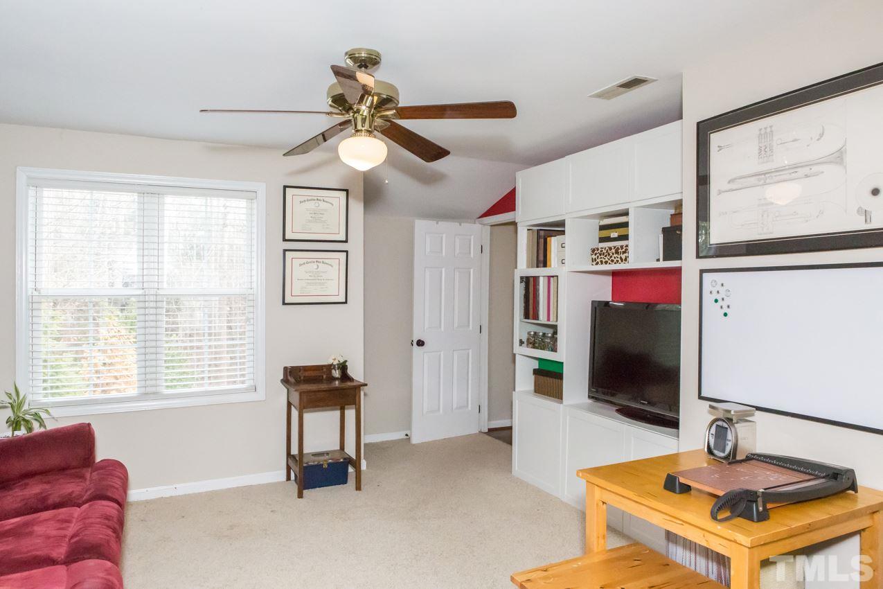 9108 Castleton Lane Raleigh, NC 27615 - Photo 17 of 25 a living room with furniture a flat screen tv and a window