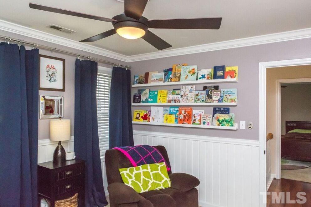 9108 Castleton Lane Raleigh, NC 27615 - Photo 19 of 25 a living room with furniture and a book shelf