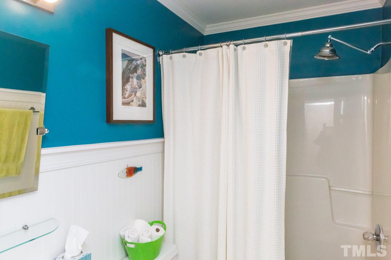 9108 Castleton Lane Raleigh, NC 27615 - Photo 21 of 25 a bathroom with a shower curtain and a sink