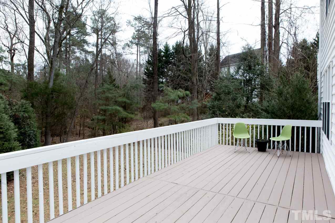 9108 Castleton Lane Raleigh, NC 27615 - Photo 24 of 25 a balcony with wooden floor and trees in the back