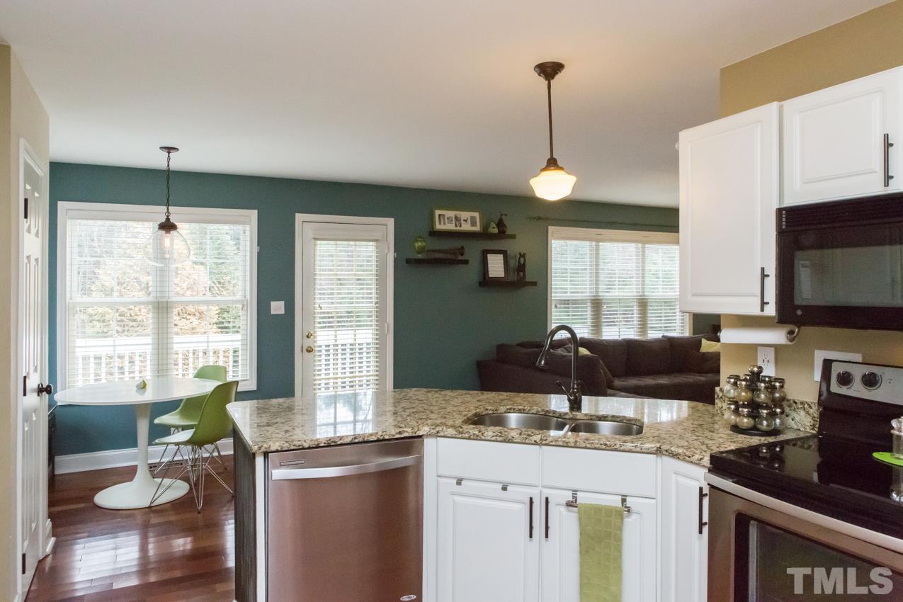 9108 Castleton Lane Raleigh, NC 27615 - Photo 7 of 25 a kitchen with a stove a sink and a refrigerator