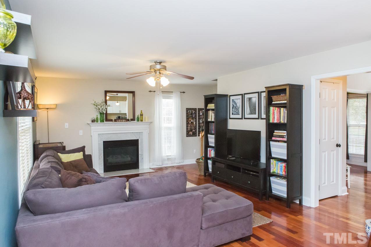 9108 Castleton Lane Raleigh, NC 27615 - Photo 10 of 25 a living room with furniture and a fireplace