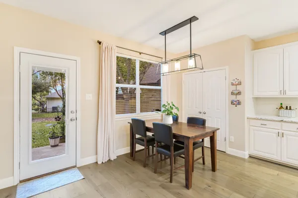 a view of a dining room with furniture window and wooden floor