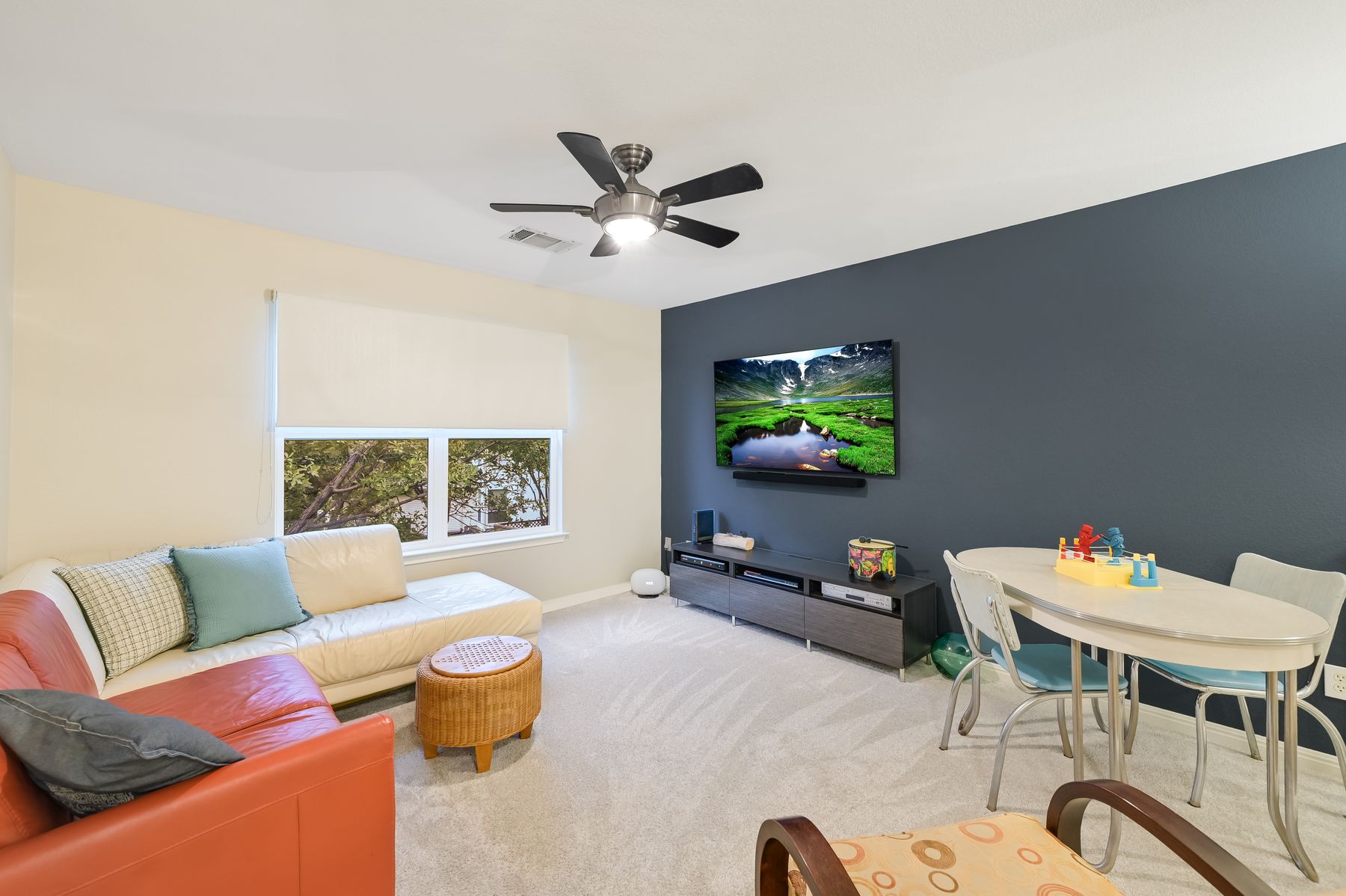 300 River Ridge Drive Georgetown, TX 78628 - Photo 13 of 32 Carpeted living area with baseboards and ceiling fan