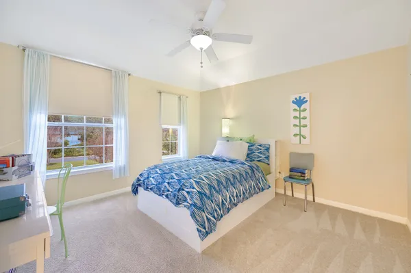 a bedroom with a bed and a chair