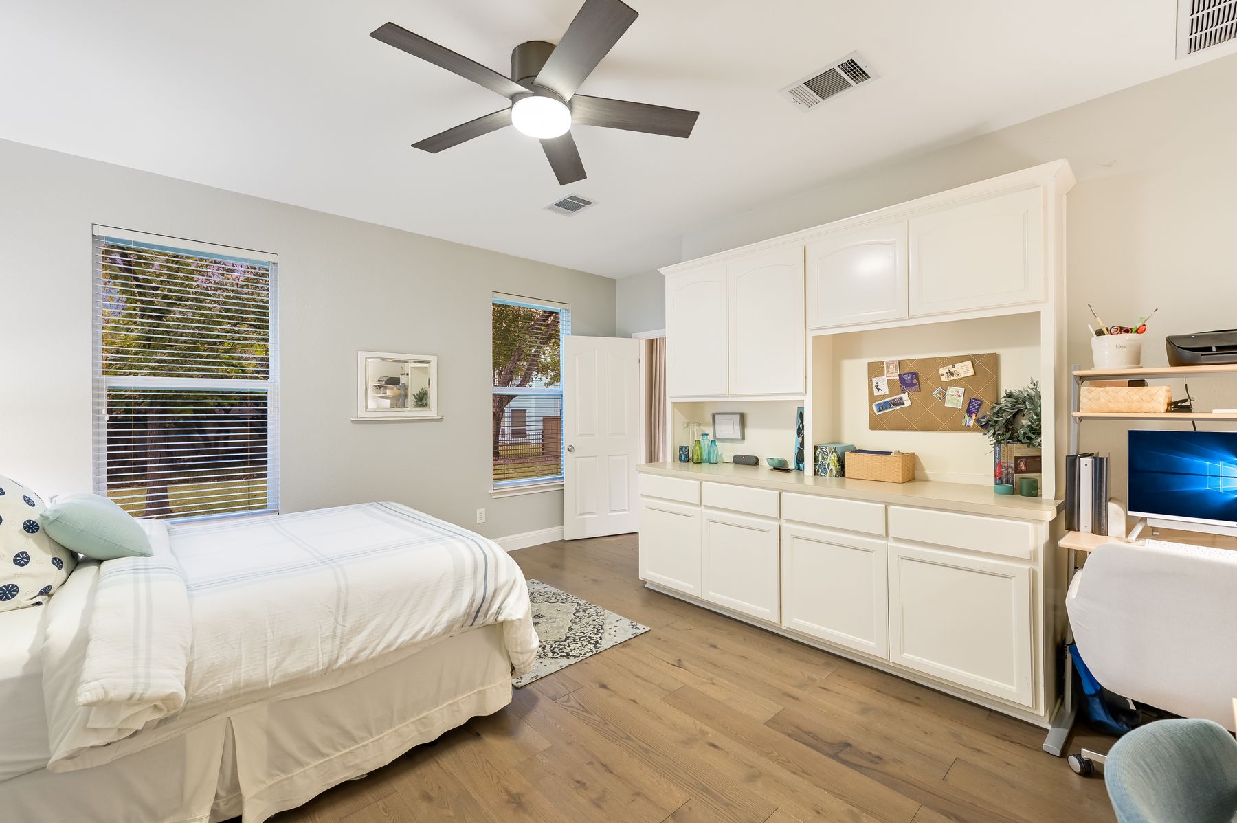300 River Ridge Drive Georgetown, TX 78628 - Photo 19 of 32 Bedroom featuring light wood-style flooring, ceiling fan, and built in desk