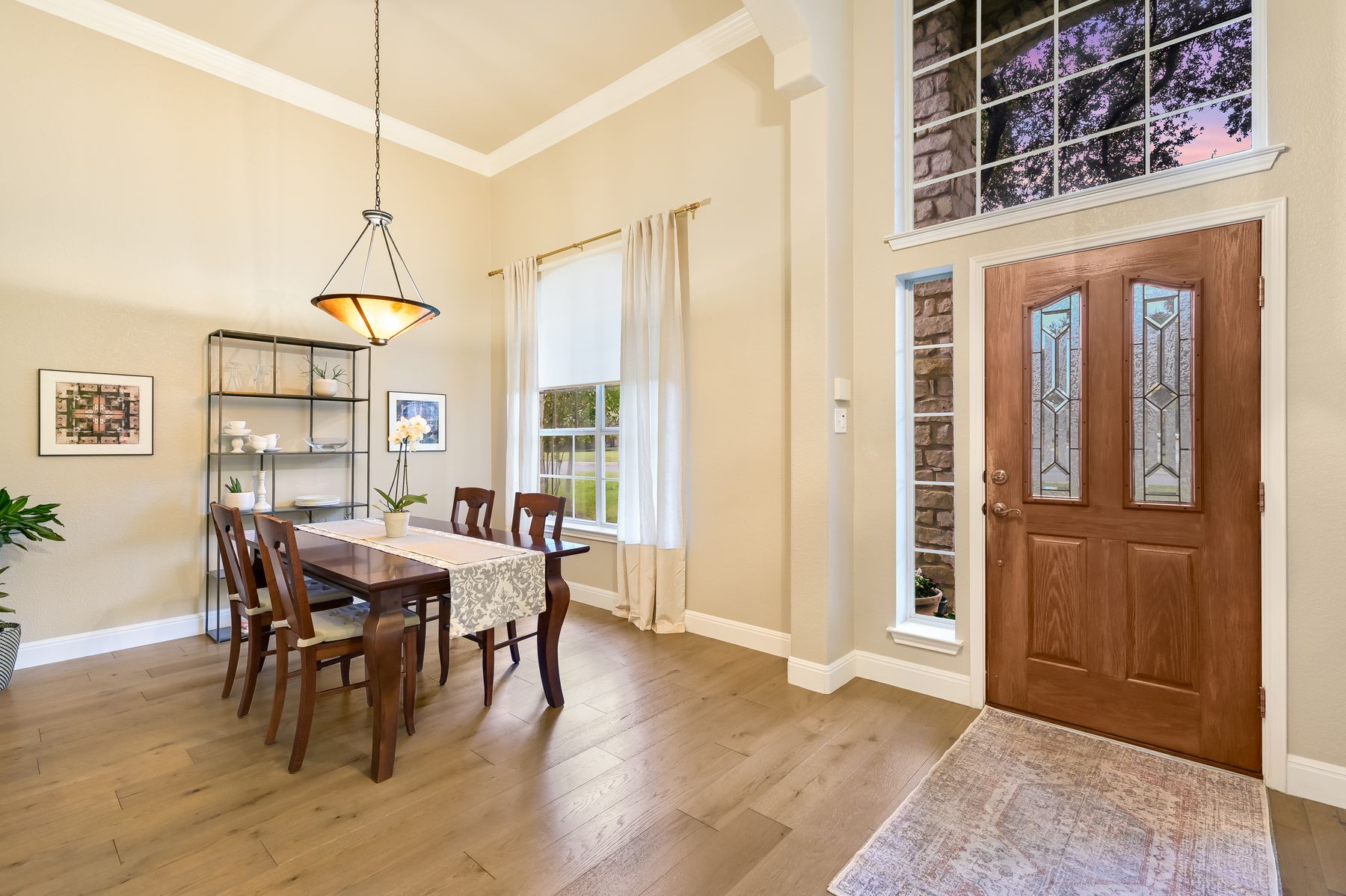 300 River Ridge Drive Georgetown, TX 78628 - Photo 2 of 32 Dining space with crown molding, light wood finished floors, and a high ceiling