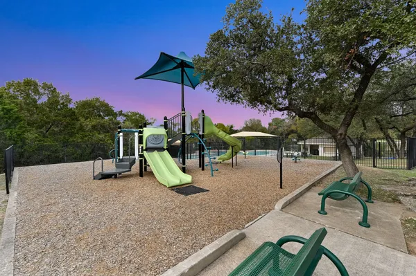 a view of a swimming pool with a yard and a sitting area